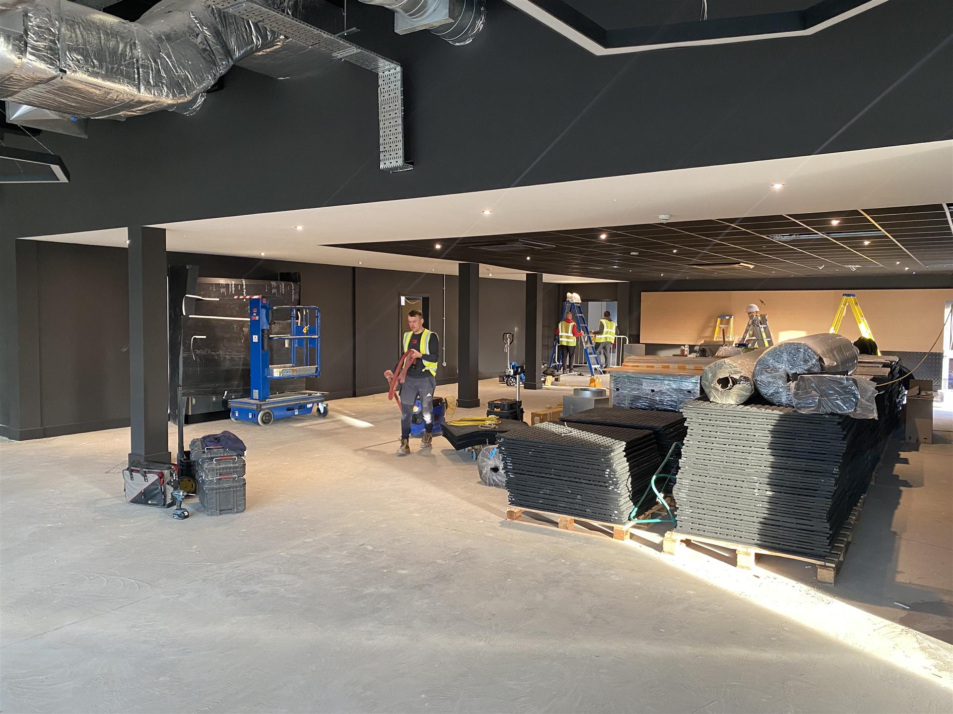 Commercial fit-out with dark walls and checker plate cladding, Essex